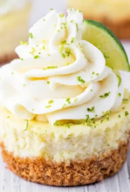 Mini key lime cheesecakes topped with whipped cream and lime zest.