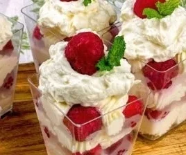 No bake lemon raspberry cheesecake cups topped with fresh raspberries.