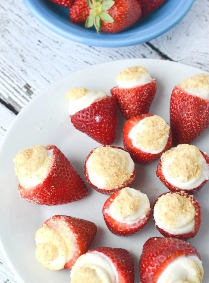 No Bake Strawberry Cheesecake Bites served on a plate with fresh strawberries
