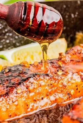 Pan-seared hot honey salmon garnished with herbs and served on a plate