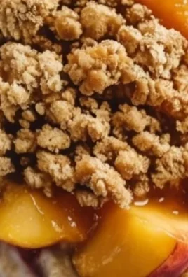 Bowl of Peach Cobbler Overnight Oats topped with fresh peaches and cinnamon.