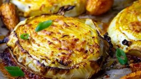 Roasted cabbage steaks topped with Parmesan cheese, a healthy veggie dish.