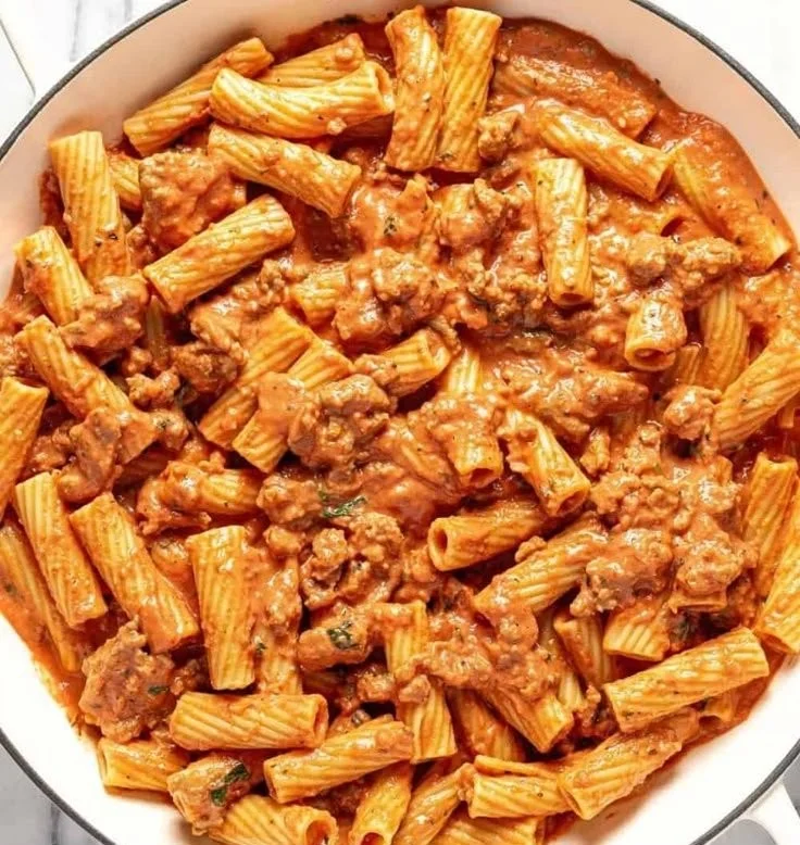 Plate of Sausage Rigatoni Pasta garnished with herbs