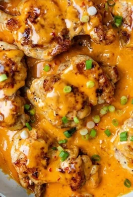 Skillet Bang Bang Chicken Thighs served with fresh vegetables and sauce