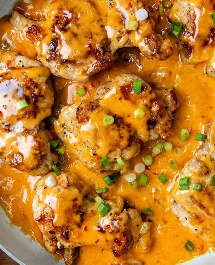 Skillet Bang Bang Chicken Thighs served with fresh vegetables and sauce