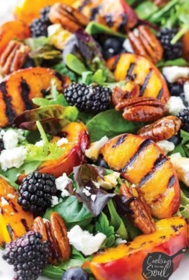 Summer grilled peach salad with fresh greens, peaches, and dressing