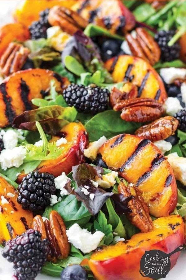 Summer grilled peach salad with fresh greens, peaches, and dressing