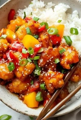 Sweet and Sour Pineapple Chicken served with vibrant vegetables on a plate.