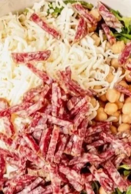 Delicious Scala Chopped Salad with fresh vegetables and dressing.