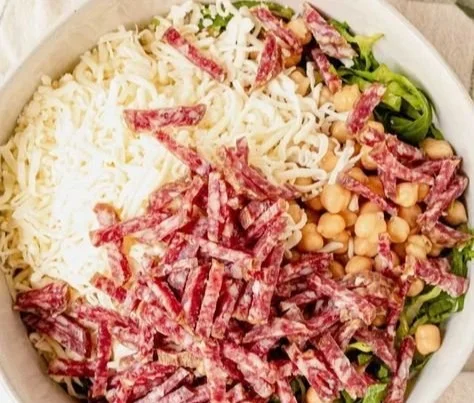 Delicious Scala Chopped Salad with fresh vegetables and dressing.