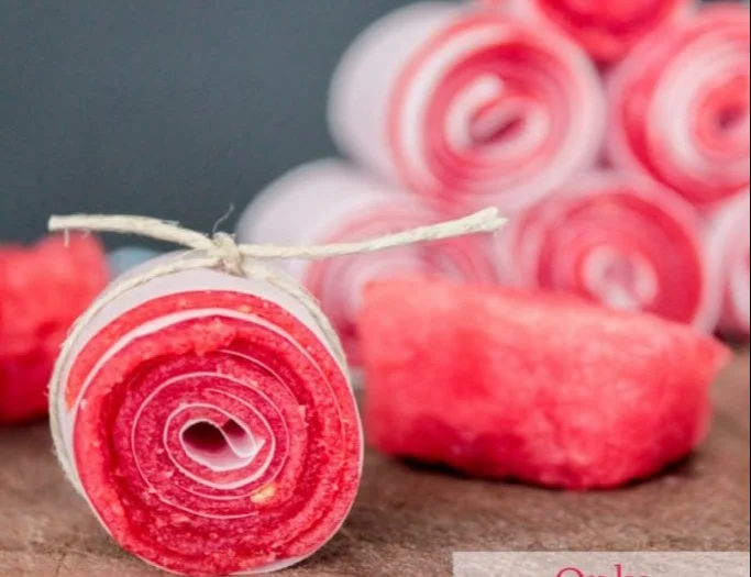 Homemade watermelon fruit leathers stacked attractively on a plate