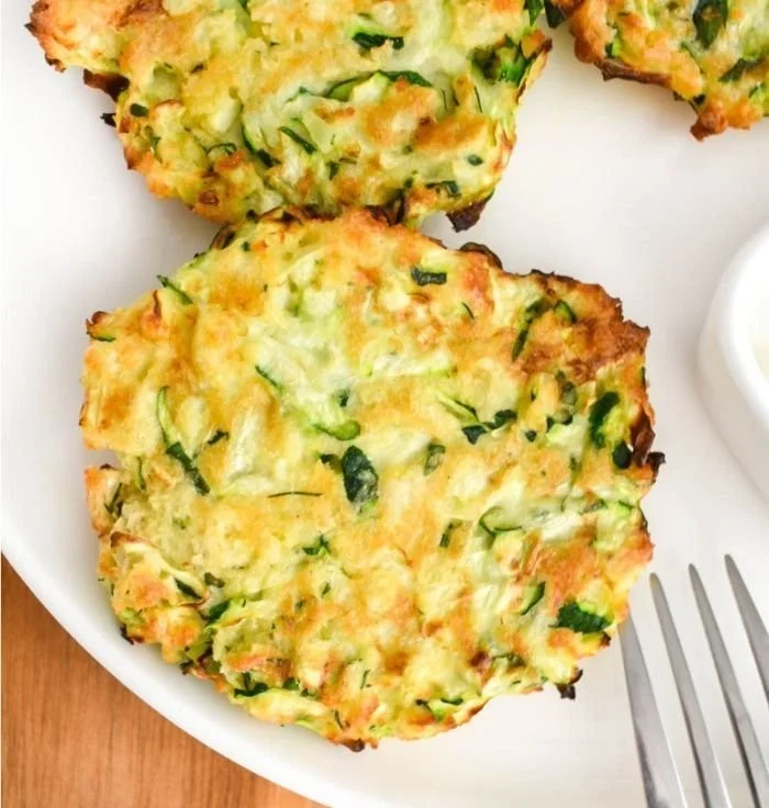 Crispy air fryer zucchini fritters served with dipping sauce