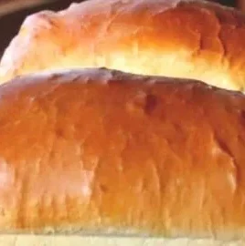 Loaf of freshly baked Amish white bread on a wooden table