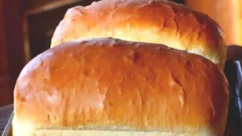 Loaf of freshly baked Amish white bread on a wooden table
