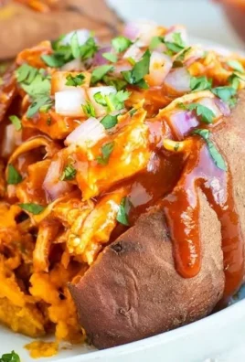 BBQ chicken stuffed in sweet potatoes, garnished and ready to serve.