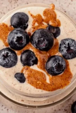 A bowl of blended overnight oats topped with fruits and nuts for a healthy breakfast