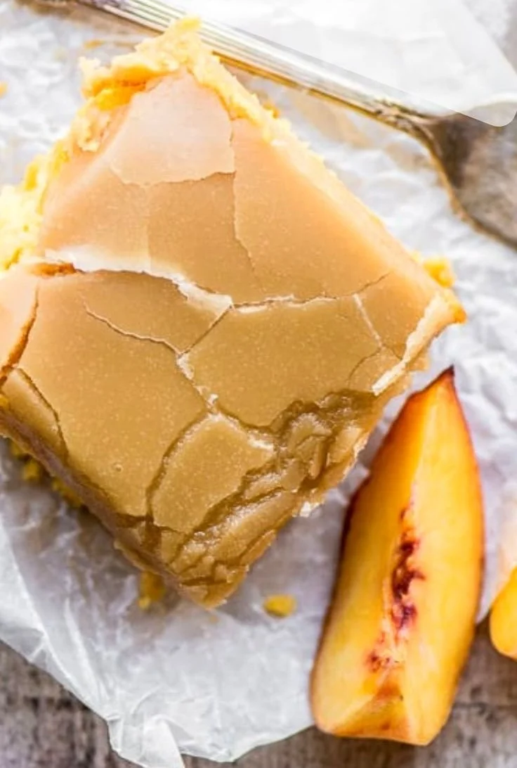 Delicious slice of brown sugar peach cake topped with fresh peaches