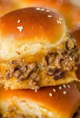 Plate of homemade cheeseburger sliders with fresh toppings and condiments