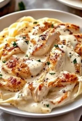 Delicious Chicken Alfredo pasta dish topped with grilled chicken and creamy sauce