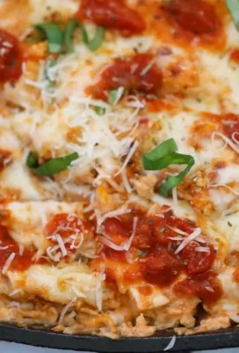 Delicious Chicken Parmesan Casserole topped with melted cheese and herbs.