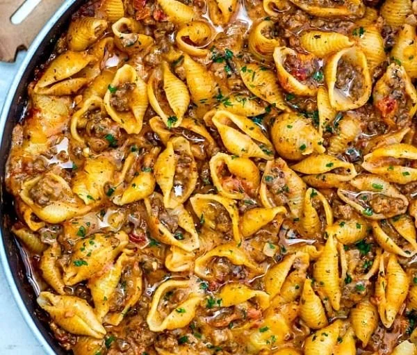 Creamy beef and shells pasta dish served in a bowl