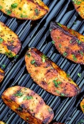 Crispy grilled potatoes served on a plate at a summer BBQ.