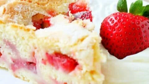 A beautifully decorated French Strawberry Cake topped with fresh strawberries