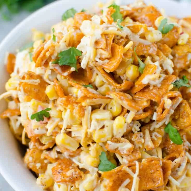 Delicious Fritos Corn Salad in a bowl with fresh ingredients and crispy Fritos