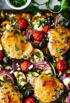Greek Sheet Pan Chicken with vegetables on a baking sheet