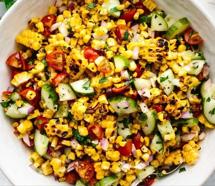 Delicious grilled corn salad featuring fresh vegetables and herbs