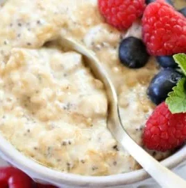 High protein oatmeal bowl topped with fruits and nuts