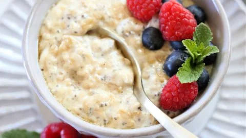 High protein oatmeal bowl topped with fruits and nuts