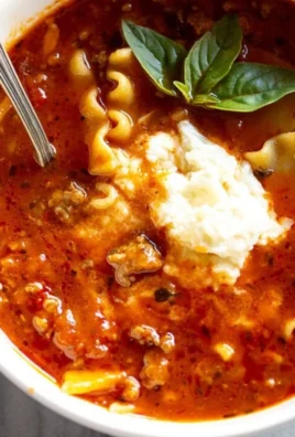 Bowl of hearty lasagna soup with pasta, cheese, and herbs