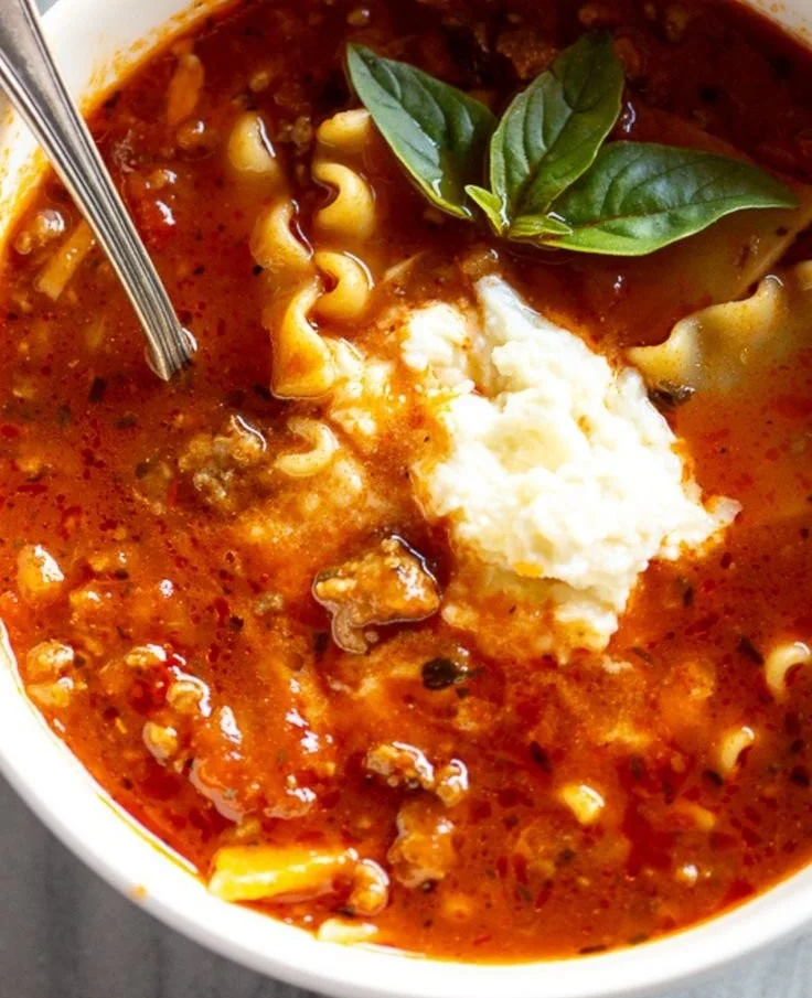 Bowl of hearty lasagna soup with pasta, cheese, and herbs