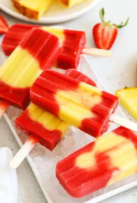 Colorful lava flow popsicles in a bowl, showcasing tropical flavors.