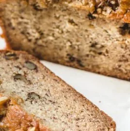 Slice of moist Maple Banana Bread on a wooden cutting board