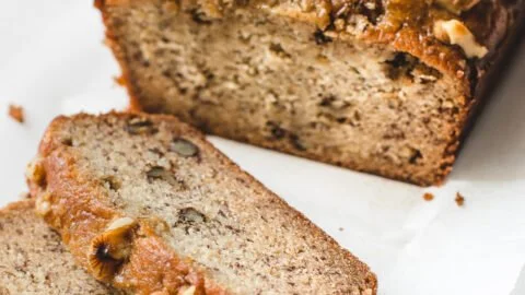 Slice of moist Maple Banana Bread on a wooden cutting board