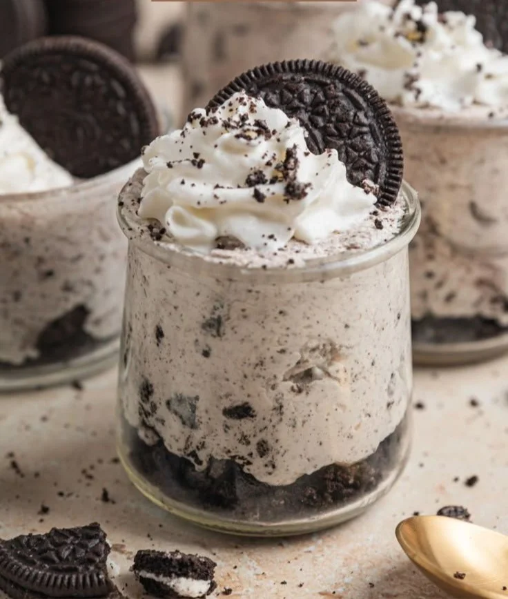 No bake Oreo cheesecake cups topped with crushed Oreos and whipped cream