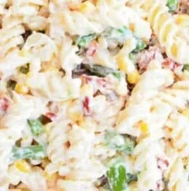 Delicious Pasta Salad topped with Creamy Parmesan Dressing in a colorful bowl.