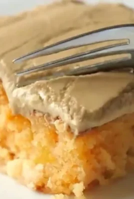 Delicious slice of peach cake topped with brown sugar frosting
