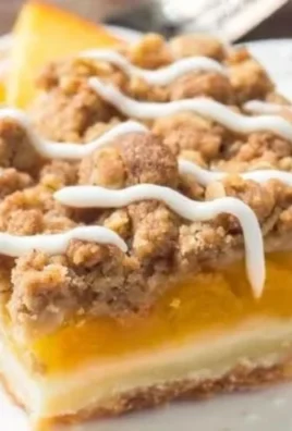 Delicious Peach Pie Crumble Bars topped with golden crumble crust