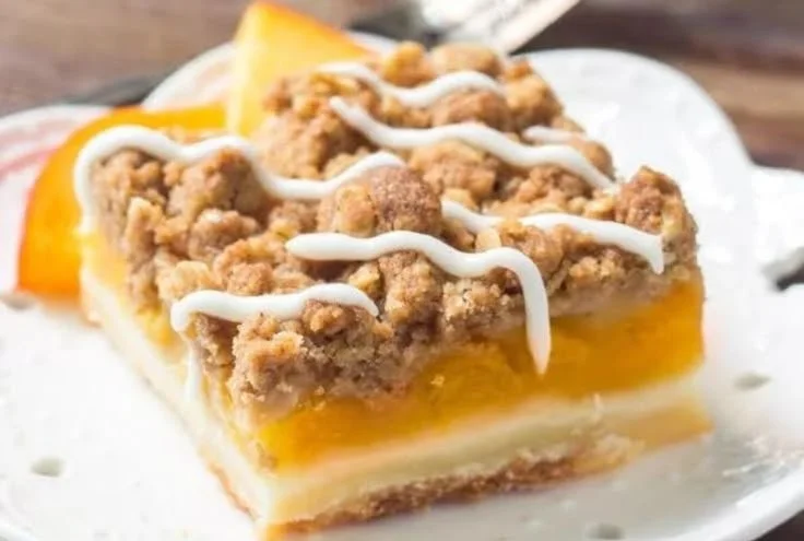 Delicious Peach Pie Crumble Bars topped with golden crumble crust