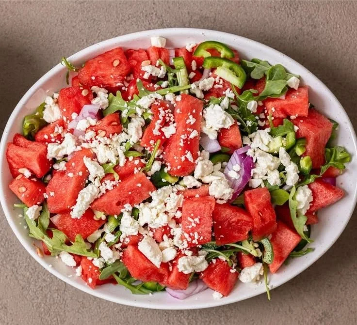 Spicy watermelon salad topped with hot honey for a refreshing summer dish.