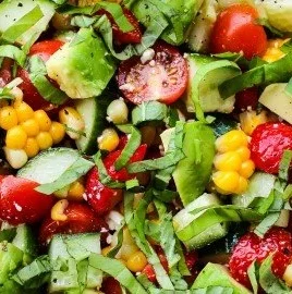 Summer salad with corn, strawberries, and avocado served in a bowl