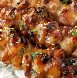 Grilled teriyaki chicken skewers garnished with vegetables.