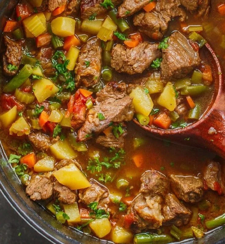 A bowl of Vegetable Beef Soup filled with vegetables and beef.